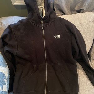 Black North Face zip up hoodie.